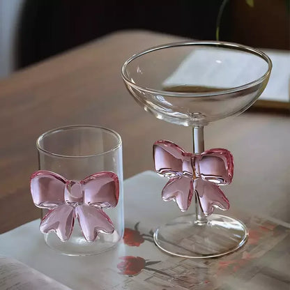 Two glass drinkware items with pink bow 