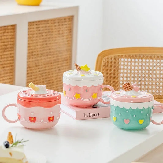 Three colourful ceramic mugs with lids