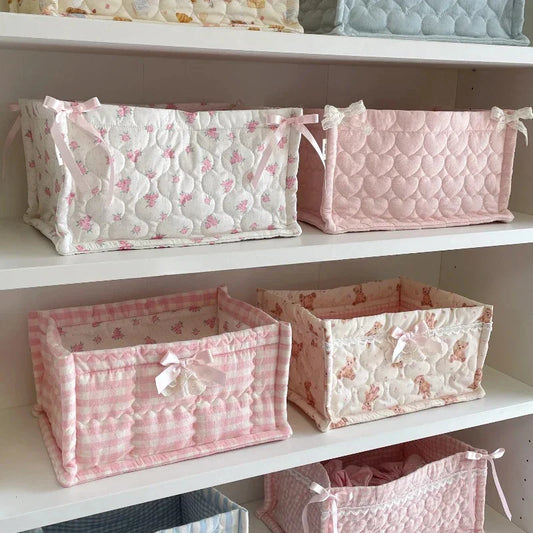 Set of pink and white patterned fabric baskets 
