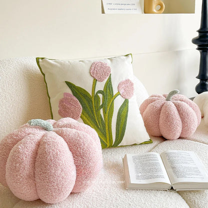 Two pink pumpkin-shaped throw pillows 