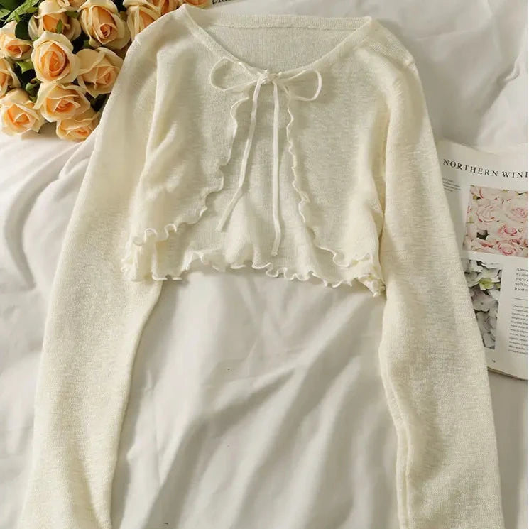 white cardigan with frilly edge 