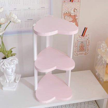 A three-layer heart-shaped shelf in pink, white, and blue
