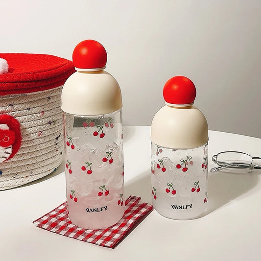 Two water bottles with red cherry designs