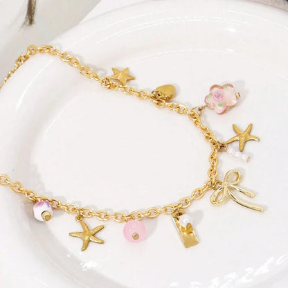 gold necklace with coquette charms 