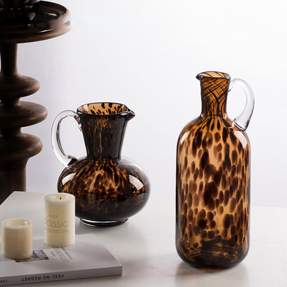 Two brown tortoiseshell glass vases with a bottle shape